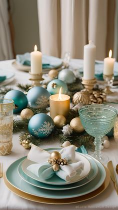 a table set for christmas with blue and gold decorations