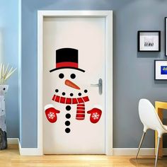 a door decorated with a snowman wearing a top hat and scarf, standing in front of a blue wall