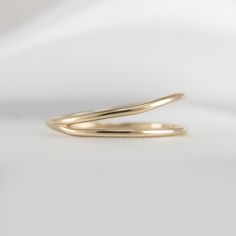 Get ready to admire the exquisite design of our Double Row Open Ring! The two layers of gold wires are intertwined flawlessly to create a polished piece that will make you shine. Crafted from 14K gold, this stunning ring is guaranteed to bring joy to your life. So go ahead and treat yourself by adding this exceptional piece to your collection! Metal: 14K yellow Gold Dimensions: 6.5mm at widest, 1.2mm wire Modern Twist Yellow Gold Stackable Rings With Open Band, Gold Double Band Stackable Rings With Modern Twist, Gold Bypass Ring With Modern Twist, Gold Double Band Rings With Modern Twist, Modern Twist Yellow Gold Stackable Rings With Polished Finish, Modern Twist Double Band Gold Rings, 14k Gold Spiral Rings, Gold Spiral Minimalist Stackable Rings, Spiral 14k Gold Ring