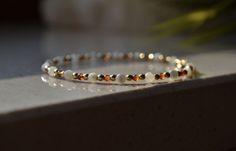 a white beaded bracelet sitting on top of a counter