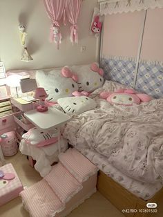 a bedroom with hello kitty decorations and pink accessories on the bed, along with other items