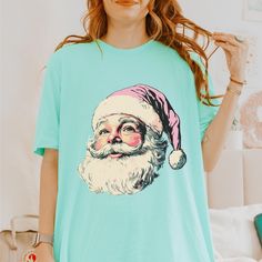 Fall in Love with Our Pink Christmas Vintage Shirt! This delightful tee combines retro charm with festive holiday vibes, making it an essential addition to your pink Christmas wardrobe. 🎀 Key Features: Soft & Comfortable: Crafted from premium materials, this shirt offers exceptional softness and comfort, perfect for all-day wear whether you're enjoying holiday activities or relaxing at home. Versatile Style: With its classic cut and enchanting design, this shirt transitions effortlessly from ca Cute Winter T-shirt With Graphic Print, Holiday Crew Neck Top With Cartoon Print, Cute Holiday T-shirt For Winter, Cute Winter Holiday T-shirt, Cute Winter Graphic Print T-shirt, Cute Holiday T-shirt With Short Sleeves, Cute Pink Christmas T-shirt, Cute Holiday Graphic Print Tops, Cute Short Sleeve T-shirt For Winter