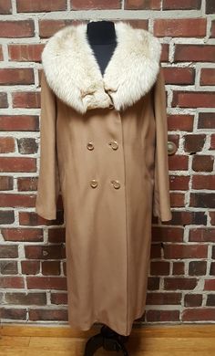 "Step out in style in this beautiful 1960's Lorendale Wool Coat with Wheat Colored Blue Fox Fur Collar in excellent condition.  The Lorendale name known for luxurious, incredible quality coats were worn by what may have been called \"high society ladies\" at that time.  The Blue Fox collar is wheat colored due to breeding for that specific trait. It is a natural fur color, not dyed. Coat is generous in fit to accommodate fuller skirts. Very lovely coat! Measured laying flat: Bust: 18\" Waist: 24\" Hips: 25\" Colar to Cuff: 29\" Shoulder to Cuff: 24\" Nape to Hem: 44\"" Retro Formal Winter Outerwear, Vintage Winter Outerwear For Formal Occasions, Vintage Outerwear For Formal Winter Occasions, Vintage Formal Winter Outerwear, Retro Long Coat For Formal Occasions, Retro Long Coat For Formal Events, 1970s Fitted Winter Outerwear, Elegant Fall Outerwear For Vintage Fashion, Elegant Vintage Fashion Outerwear For Fall