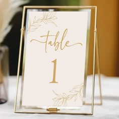 a table number is displayed on a gold frame