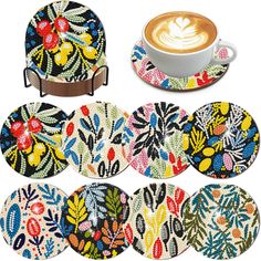 six coasters with different designs on them and a cup of cappuccino