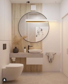 a bathroom with a round mirror above the sink and toilet next to an open door