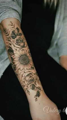 a woman's arm with sunflowers on it