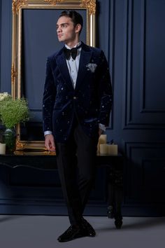 Blue tuxedo featuring stud detailing on the sleeves and front. Paired with a pintuck detailed front shirt, a solid black trouser, a pocket square, a bow tie and a waist band. - Aza Fashions Designer Blue Suits For Party, Luxury Blue Suits For Festive Occasions, Luxury Blue Suits For Festive Season, Designer Blue Party Suits, Blue Winter Tuxedo For Formal Occasions, Luxury Blue Blazer For Groom, Festive Blue Blazer For Groom, Blue Slim Fit Long Sleeve Tuxedo, Blue Tuxedo For Semi-formal Winter Occasions