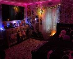 a bedroom decorated in pink and purple lights