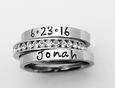 "This GOREOUS 3 mm ring is super shiny, solid stainless steel. Great for stacking. The surface is flat, so the lettering really stands out! Add names, initials, dates, quotes, roman numerals or scripture. I have the heart, double heart, infinity, #, &, @, !, =, *, :, ?, cross, baby foot, angel, and ribbon stamps. Made of solid surgical Stainless steel which will never rust, tarnish, change color and is hypoallergenic. I ONLY stamp on the outside of the rings. I hand stamp each letter, then u Custom Name Adjustable Stackable Wedding Rings, Custom Name Adjustable Stackable Rings For Personalized Gift, Custom Name Rings For Mother's Day Promise, Custom Name Promise Ring For Mother's Day, Stainless Steel Stackable Promise Ring, Adjustable Stainless Steel Stackable Rings As Promise Rings, Adjustable Stainless Steel Stackable Rings For Promise, Personalized Stackable Rings For Mother's Day Wedding, Mother's Day Promise Ring With Names