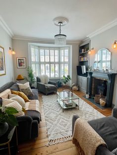 a living room filled with furniture and a fire place