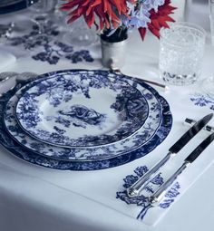 a blue and white table setting with silverware