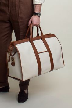 Color: Ivory Canvas Luxury White Tote Travel Bag, Luxury White Travel Bag For Daily Use, White Leather Handled Tote Travel Bag, Classic Beige Weekender Bag With Leather Handles, Luxury Beige Duffle Bag With Large Capacity, Classic White Rectangular Weekender Bag, Classic Beige Duffle Bag With Leather Handles, Classic Beige Rectangular Duffle Bag, White Satchel Duffle Bag With Luggage Sleeve