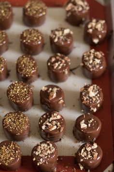 there are many chocolates on the tray ready to be eaten and served in the oven