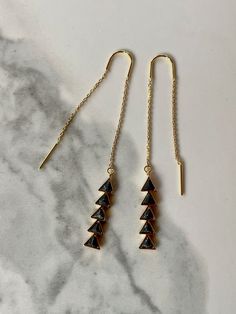 "Fine and delicate, these earrings flow from the earlobe in a beautiful golden line. Length can be adjusted depending how far the chain is pulled through the ear. The chains measure 55mm in length, and the black marble charms add another 1\" in length. Threader earrings come with wire ends to make it easy to thread the chain through any pierced hole of your ear, making these earrings fun to wear and play around with (from one pierced hole to another). Their versatility is what makes them so popu Minimalist Triangle Jewelry For Pierced Ears, Minimalist Threader Earrings With Adjustable Chain For Party, Minimalist 14k Gold Filled Earrings For Party, Minimalist 14k Gold Filled Party Earrings, Minimalist Black Linear Earrings For Gifts, Minimalist Black Linear Earrings As Gift, Triangle Ear Wire Jewelry For Gifts, Black Oak Tree, Earring Minimalist