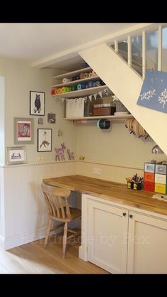 a kitchen with an open staircase leading up to the second floor