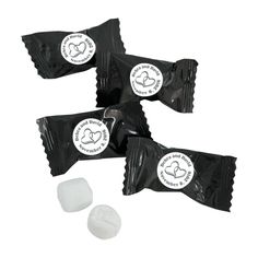 three pieces of candy sitting next to each other on a white surface with black and white stickers