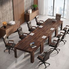 a conference table with chairs around it in the middle of a large room filled with windows