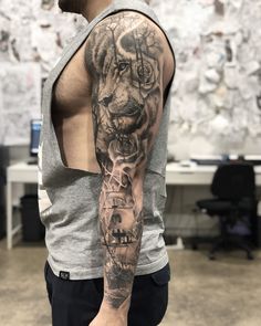 a man with a tiger tattoo on his arm and shoulder is standing in an office