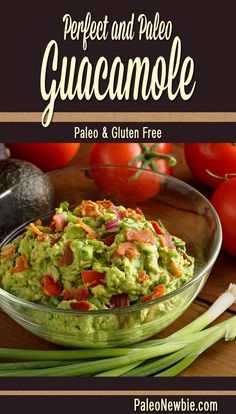 guacamole in a glass bowl with green onions, tomatoes and celery