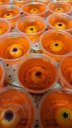 many plastic cups filled with orange liquid