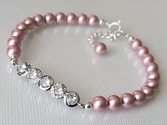 Wedding Powder Rose Blush Pink Colored Pearl Cubic Zirconia Dainty Bridal Bracelet. BRACELET is about 7.32 inches (18.6cm) long plus 1 inch extender chain. BRIDAL EARRINGS SECTION: https://www.etsy.com/shop/LanaChayka?ref=seller-platform-mcnav§ion_id=11638940 BRIDAL JEWELRY SETS SECTION: https://www.etsy.com/shop/LanaChayka?ref=seller-platform-mcnav§ion_id=25839214 BRIDAL NECKLACES SECTION: https://www.etsy.com/shop/LanaChayka?ref=seller-platform-mcnav§ion_id=11638944 Elegant and simple, this stunning bracelet is perfect for weddings or special occasions such as birthdays, anniversaries, graduations, proms...or whatever you can imagine! Handmade bracelet, is made with Powder Rose Blush Pink colored high quality European round crystal pearls, Rhodium Plated connector with Clear Cubic Zircon Pink Pearl Bracelet For Wedding, Adjustable Pink Pearl Bracelet For Weddings, Adjustable Pink Crystal Bracelet For Wedding, Adjustable Rose Gold Pearl Bracelet For Wedding, Crystal Bracelet With Round Beads For Wedding, Adjustable Rose Gold Beaded Bracelet For Wedding, Elegant Pink Crystal Bracelet, Adjustable Pink Bracelets For Wedding, Adjustable Pink Beaded Bracelets For Wedding