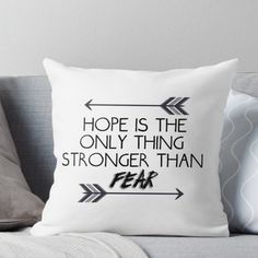 a black and white pillow with the words hope is the only thing stronger than fear