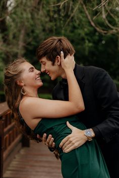 a young man and woman embracing each other