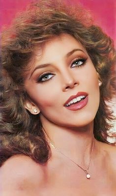 a close up of a woman with long hair and blue eyes wearing pearls on her necklace