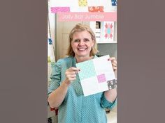 a woman holding up a piece of paper with the words july bar jumble on it