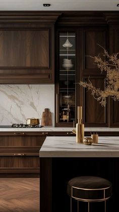 a kitchen with marble counter tops and wooden cabinets, along with stools in the center