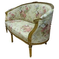 an ornately decorated chair with gold trimmings and floral upholstered fabric