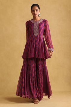 Purple short peplum kurta with floral prints and embroidered placket. Comes with matching printed sharara. Components: 2 Pattern: Printed Type Of Work: Floral Neckline: Round Sleeve Type: Full Fabric: Chiffon Color: Purple Other Details:  Embroidered yoke and sleeve hem Occasion: Sangeet - Aza Fashions Brocade Kurta, Western Party Wear, Kurta And Sharara Set, Organza Cape, Printed Sharara, Kurta And Sharara, Kurta Sharara, Light Pink Shorts, Western Party