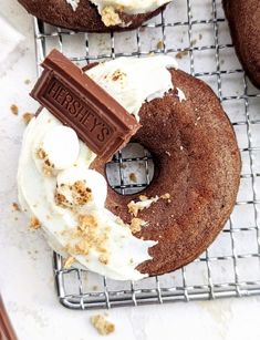 chocolate donuts with white frosting on a cooling rack