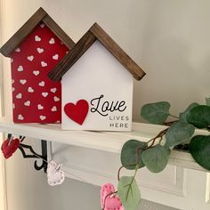 a couple of small houses sitting on top of a shelf