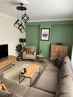 a living room filled with furniture and a flat screen tv on top of a wooden table