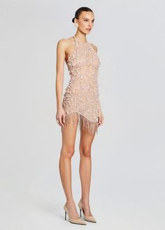 Dazzle and delight in our Livana Dress, featuring a chic high neck, alluring open back, and a playful fringed hem. Elevate your style game with this stunning ensemble that's guaranteed to make a statement at any event. Whether you're hitting the dance floor at a cocktail party or making a grand entrance at a special ev Fitted Mini Dress With Beaded Fringe, Chic Fringe Flapper Dress For Party Season, Glamorous Beaded Fringe Dress For Date Night, Mini Flapper Dress With Fringe For Party Season, Summer Party Flapper Dress With Beaded Fringe, Beaded Fringe Mini Dress For Gala, Glamorous Fringe Dress For Date Night, Summer Cocktail Flapper Dress With Tassels, Fitted Mini Flapper Dress With Fringe