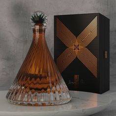 a brown glass vase sitting next to a black box