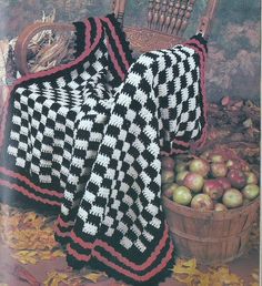 an image of a crocheted blanket and basket of apples