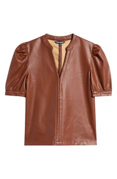 With its charming puff sleeves and tough faux-leather design, this chic top makes sure you achieve the perfect mix of sweet and edgy. 23 1/2" length (size Medium) Split neck Short sleeves 100% polyurethane Spot clean Imported Leather Tops For Office In Fall, Leather Top For Office In Fall, Elegant Leather Tops For Fall, Brown Puff Sleeve Tops For Fall, Chic Brown Workwear Tops, Chic Brown Tops For Workwear, Chic Brown Tops For Work, Brown Leather Casual Tops, Trendy Faux Leather Tops For Fall