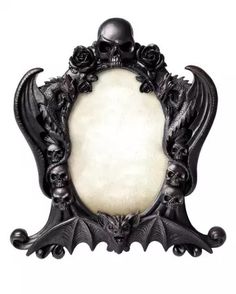 an ornate frame with a skull and roses on it, decorated in gothic style decorations