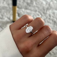 a woman's hand with a diamond ring on it