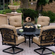 an outdoor table with chairs around it