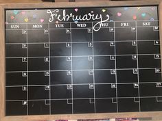 a chalkboard calendar with the word february written on it and confetti sprinkles