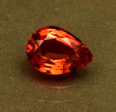 an orange colored diamond sitting on top of a table next to a green countertop