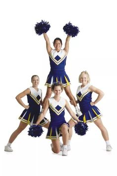 four girls in cheerleader outfits posing for the camera with their hands up and one girl holding two pom poms