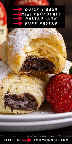 two chocolate filled pastries on a plate with strawberries