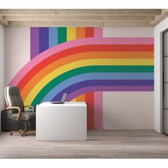 an office with a rainbow wall mural in the background and a chair next to it