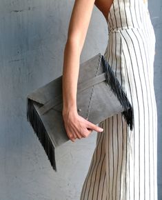 "Medusa Clutch in gray. An adorable leather clutch with fringes for beautiful fashion looks. This envelope clutch is ideal to carry anything you might need! A handmade clutch from Italian genuine suede leather in gray colour and silk fringes. The interior is fully lined with gray leatherette. It closes with one metal rivet stud in silver or gold. The pictures show the clutch with silver stud. Dimensions: Height 23 cm (9,06\"), Length 32 cm (12,6\") Do you want to use your clutch as a shoulder ba Chic Clutch With Tassels, Chic Rectangular Clutch With Fringe, Chic Rectangular Fringe Clutch, Envelope Clutch Purse, Gray Colour, Leather Envelope Clutch, Leather Fringe Bag, Leather Envelope, Handmade Clutch