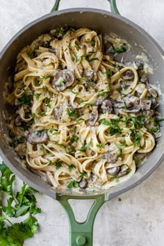 pasta with mushrooms and parsley in a skillet